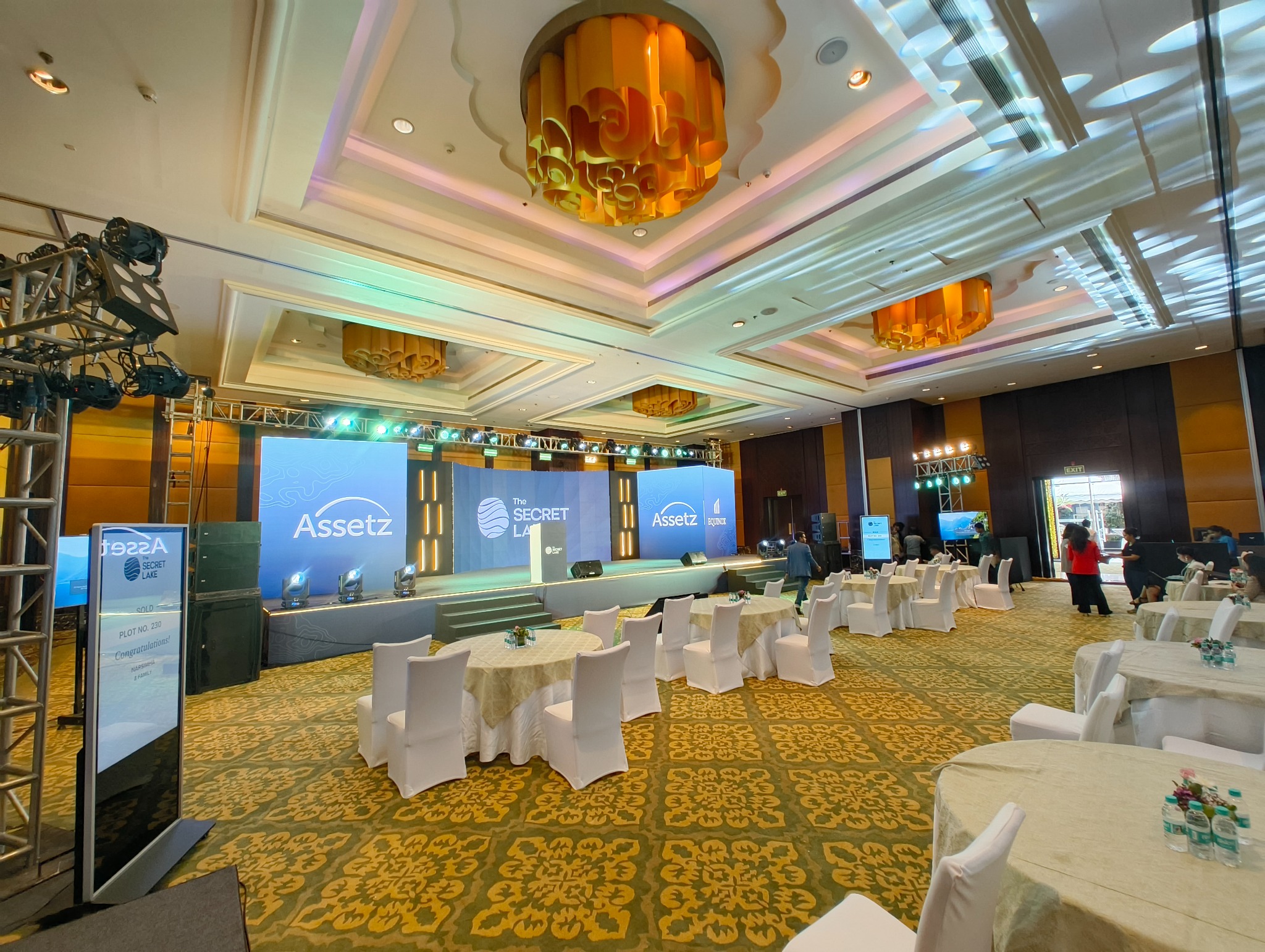 Assetz event setup with branded stage and launch environment